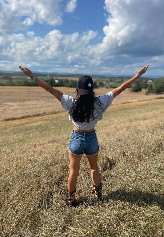 Disconnect to Reconnect- How Nature Improves Mental Health - a woman enjoying nature with arms outstretched in a field.
