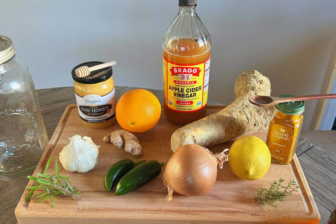Ingredients for Homemade Fire Cider Recipe including vinegar, honey, garlic, and fresh herbs.