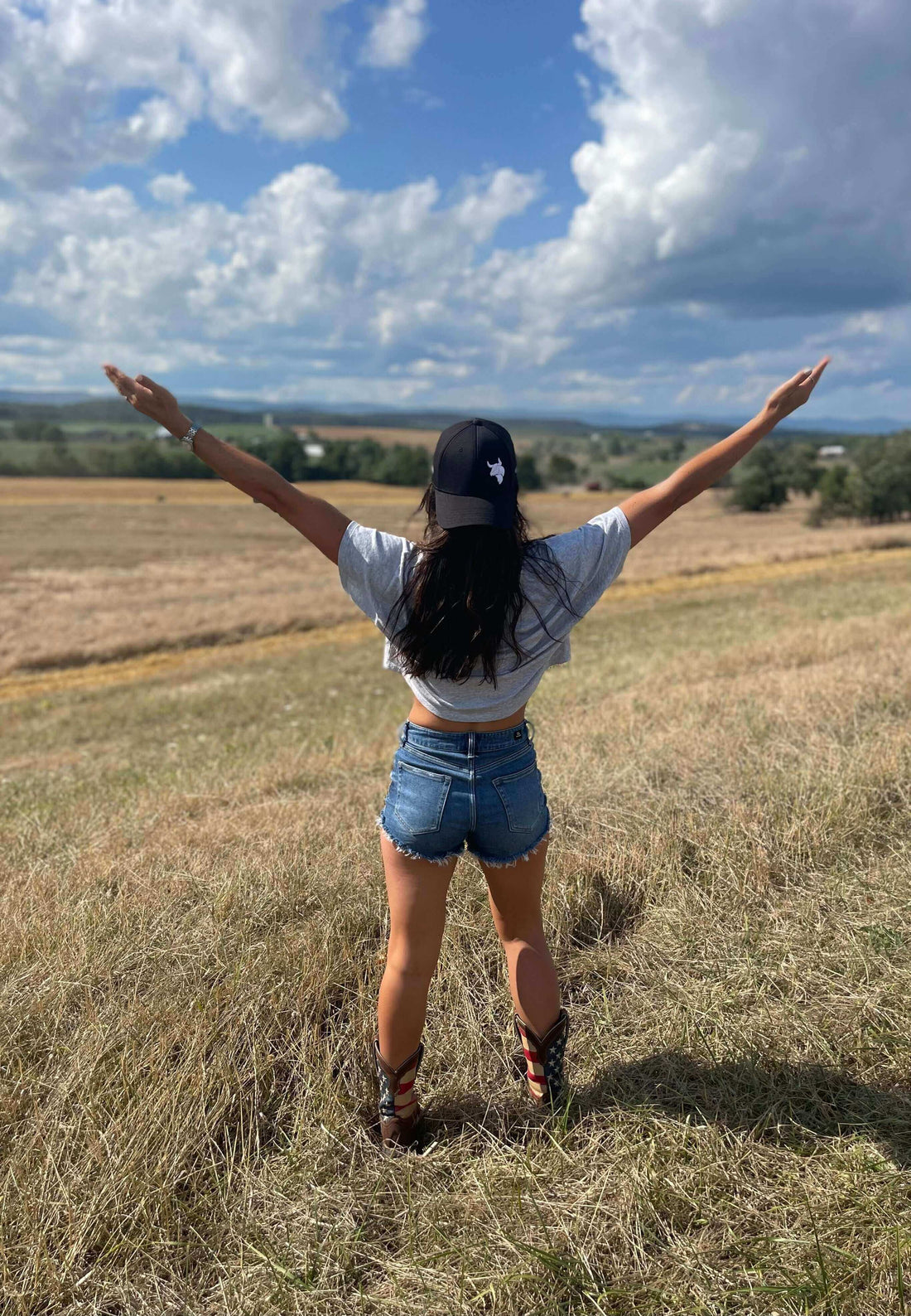 Disconnect to Reconnect- How Nature Improves Mental Health - a woman enjoying nature with arms outstretched in a field.