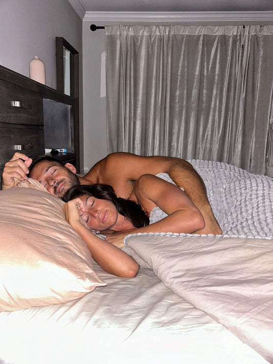 Benefits of Quality Sleep for Health and Longevity - couple sleeping peacefully in comfortable bedroom.