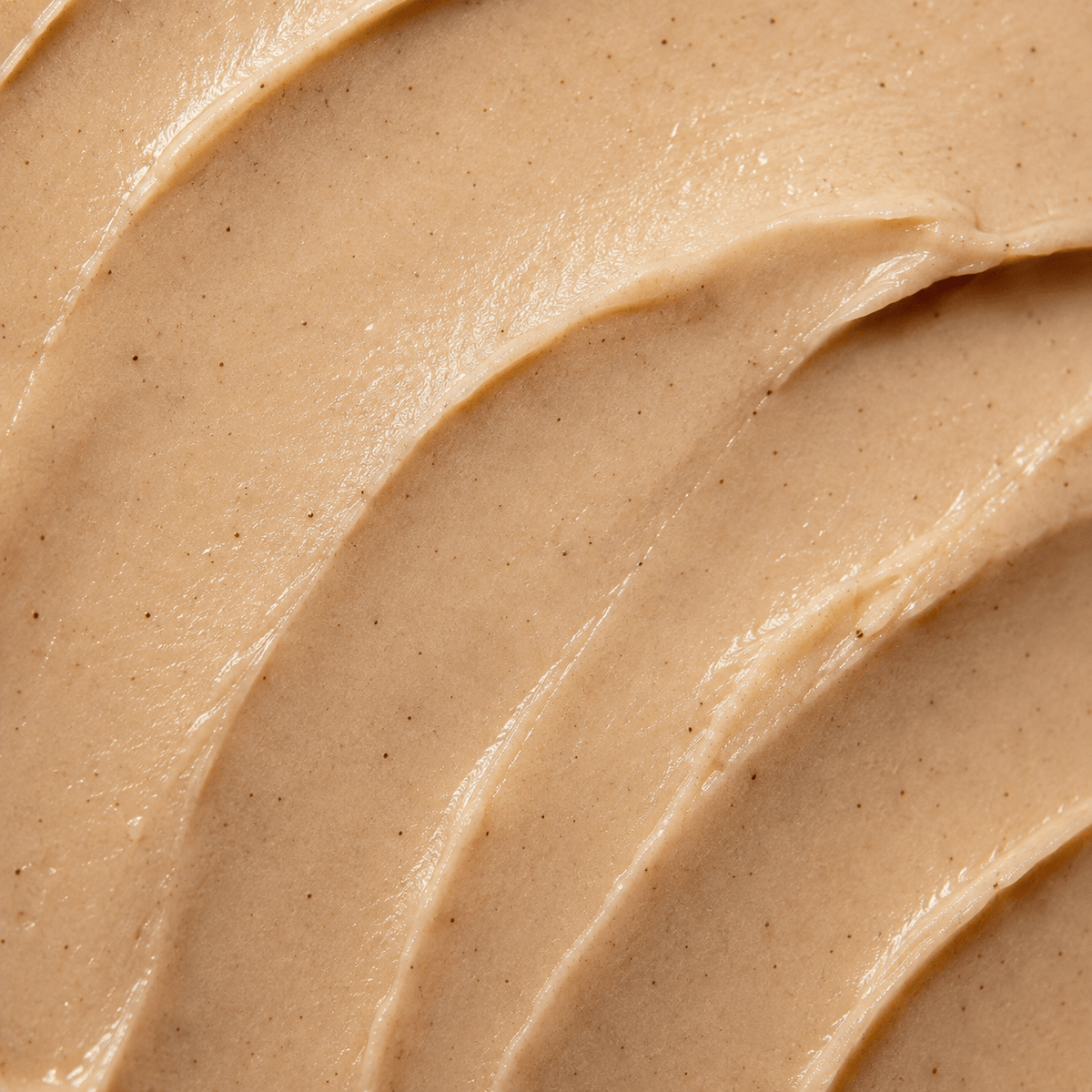Close-up of creamy texture of Cinnamon Spice Lip Balm, showcasing its rich and nourishing formula.