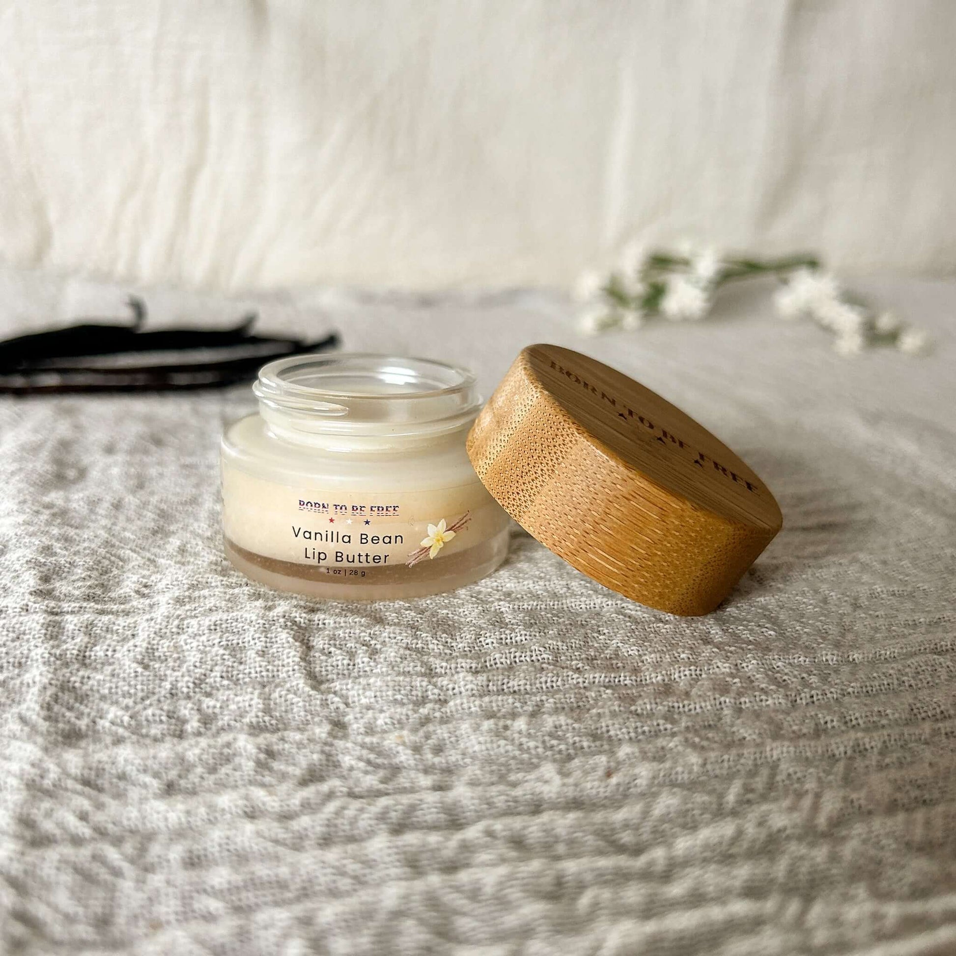Vanilla Bean Lip Butter in a jar with a bamboo lid, designed for moisturizing and soothing dry lips.