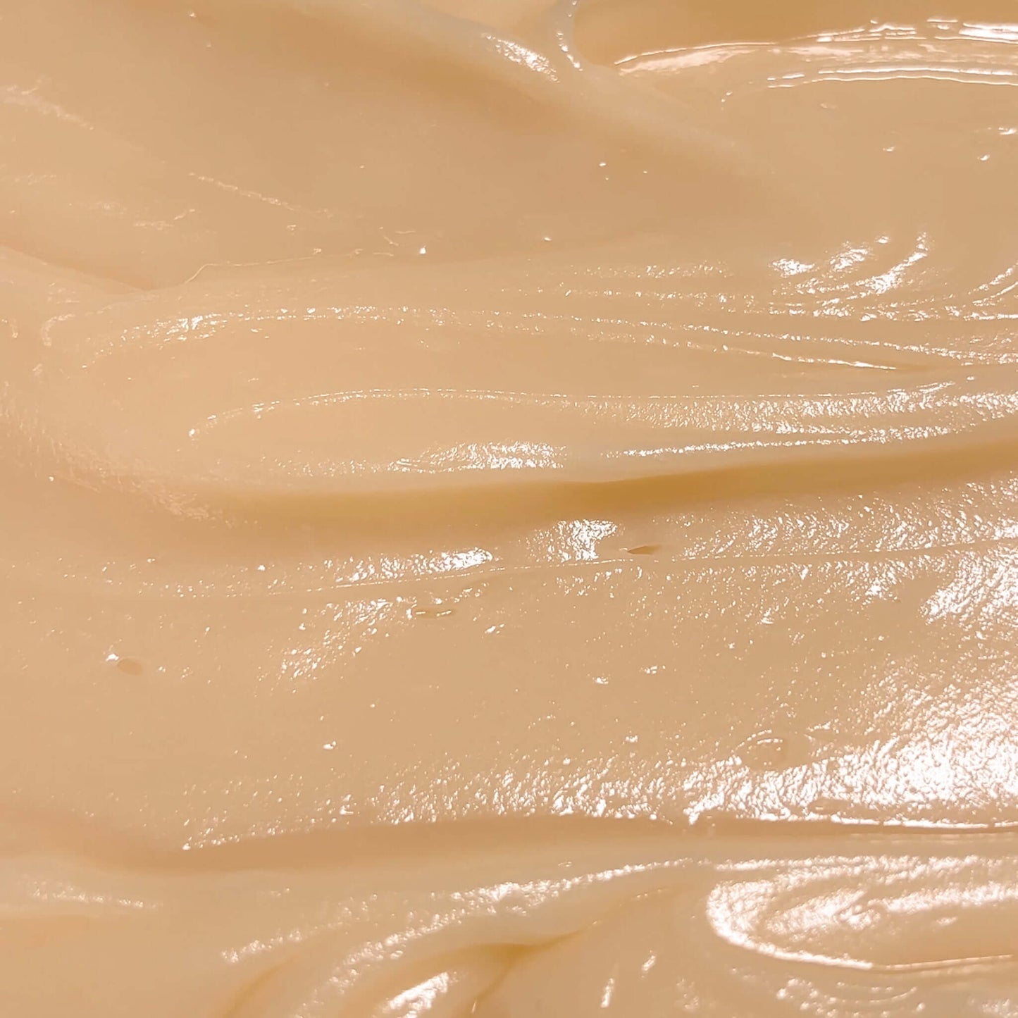 Close-up of silky Extra Hydrating Body Butter texture, showcasing its creamy and nourishing properties.