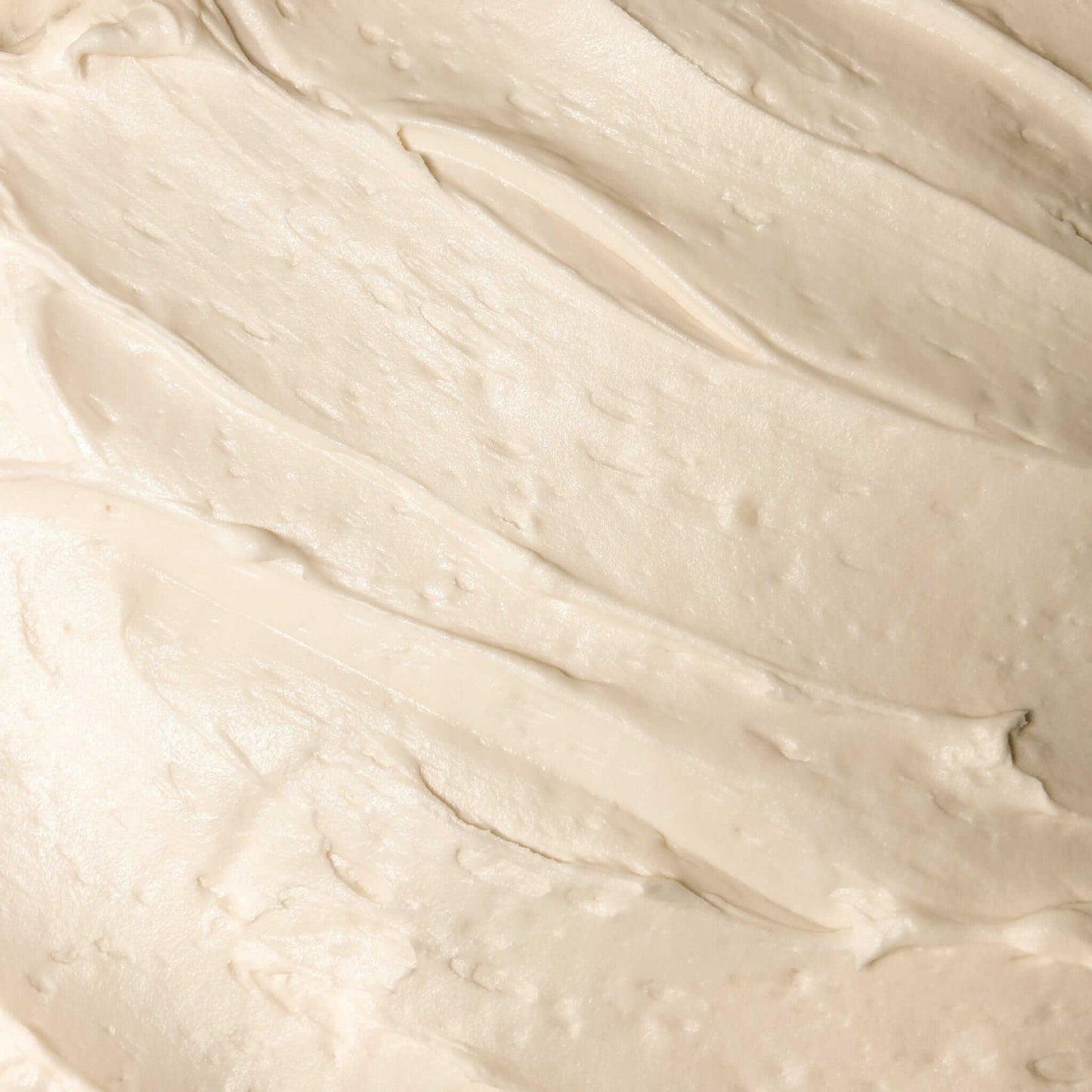 Hydrating Face Butter without Essential Oils spread on a surface, showcasing its creamy texture and luxurious consistency.