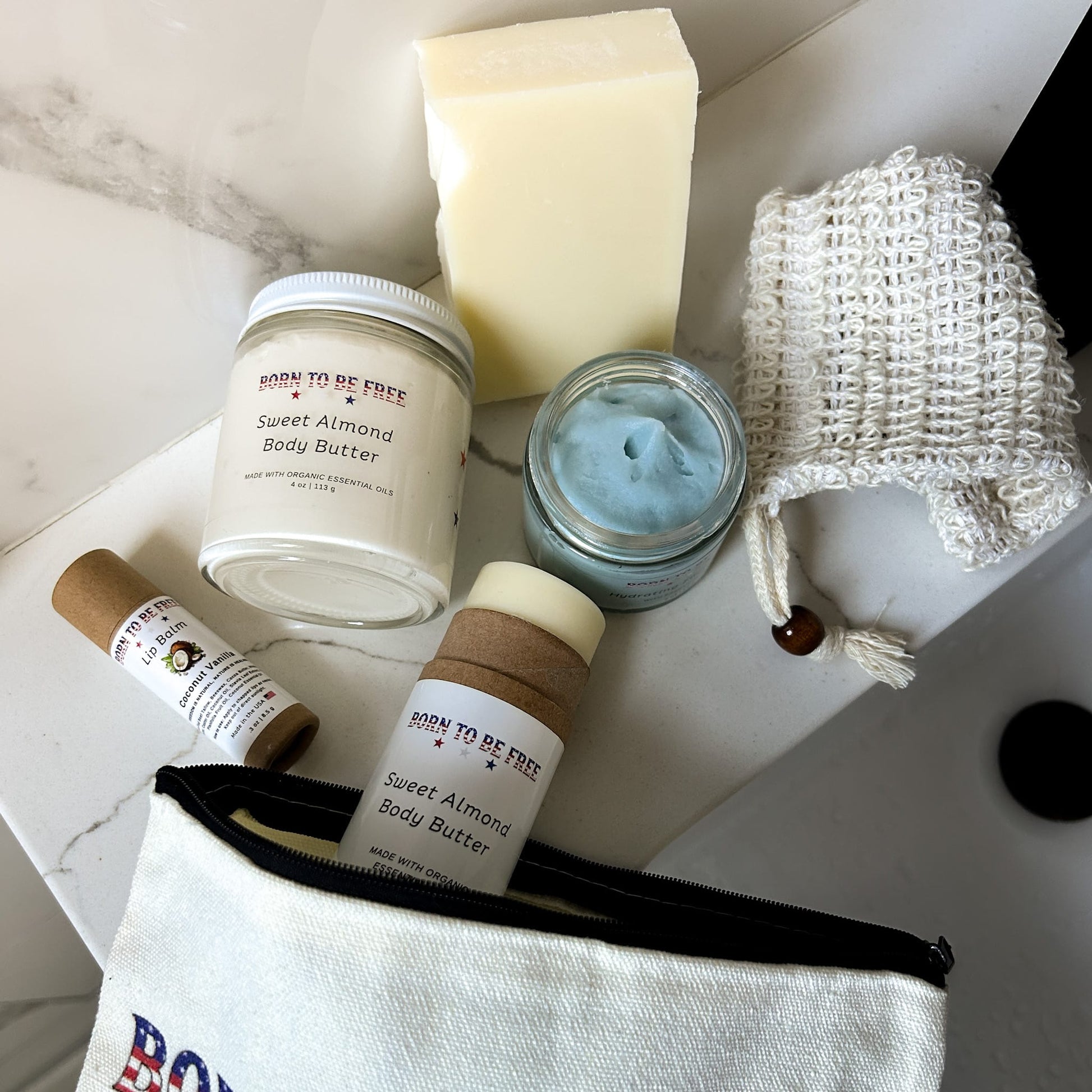 Stars & Stripes Collection with Sweet Almond Body Butter and natural skincare products on a marble surface.