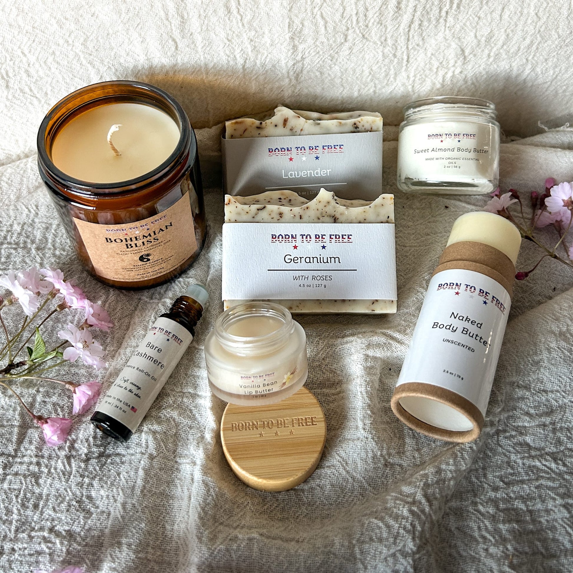 The Mothers Day Collection featuring luxury skincare and clean fragrances arranged with floral accents.