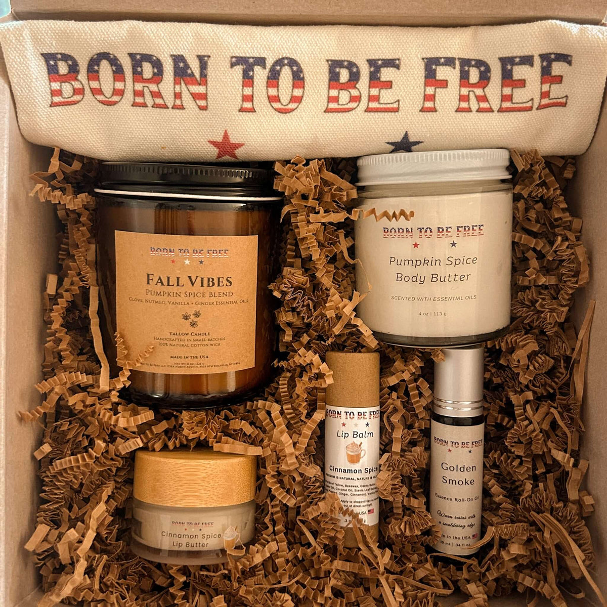 The Fall Ritual Set featuring pumpkin spice candle, body butter, lip balm, and more in a cozy box.
