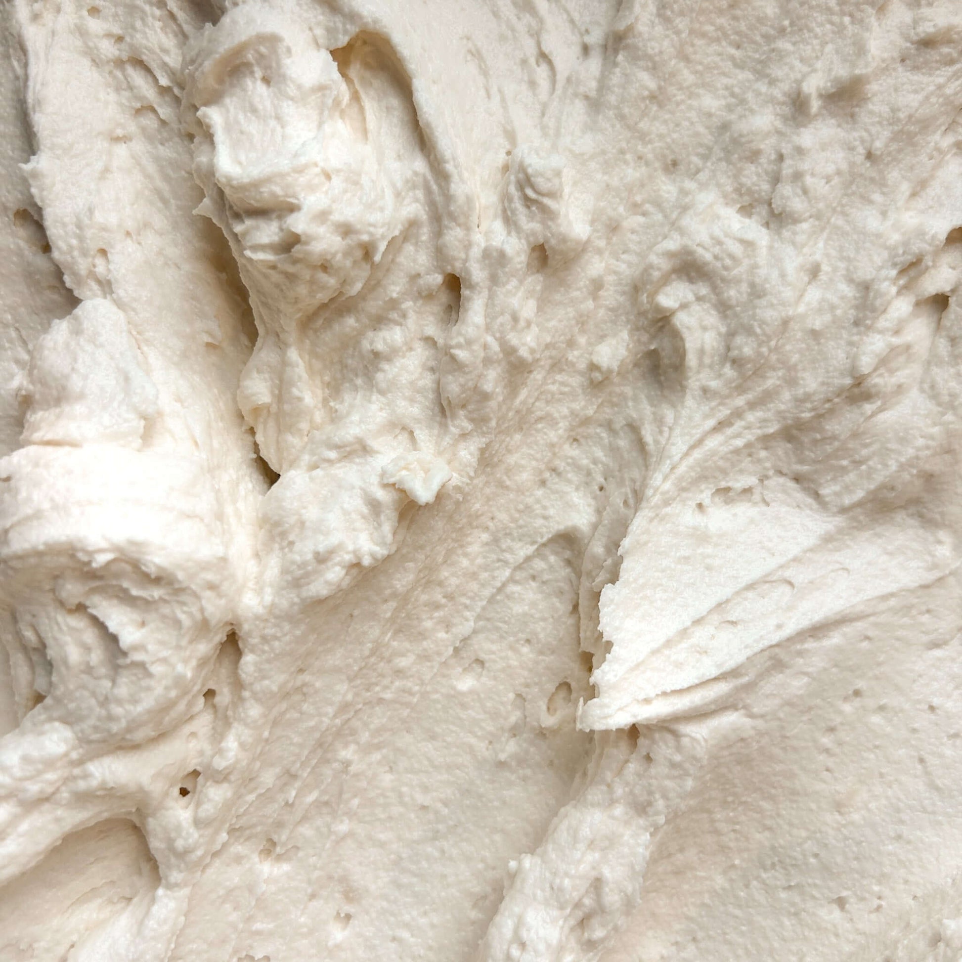 Close-up of smooth and creamy Vanilla Bean Body Butter texture, showcasing its rich, whipped consistency.