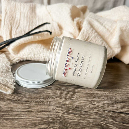 Vanilla Bean Body Butter jar on wooden surface with textured fabric, showcasing a rich moisturizer for healthy skin.