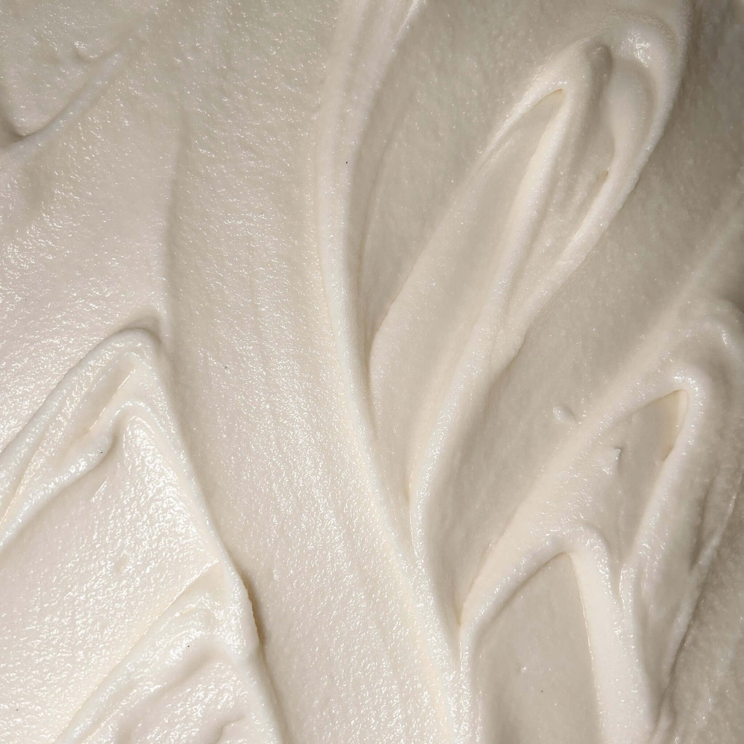 Creamy texture of Smoked Cedar Body Butter, a rich moisturizer for deeply nourishing and hydrating the skin.