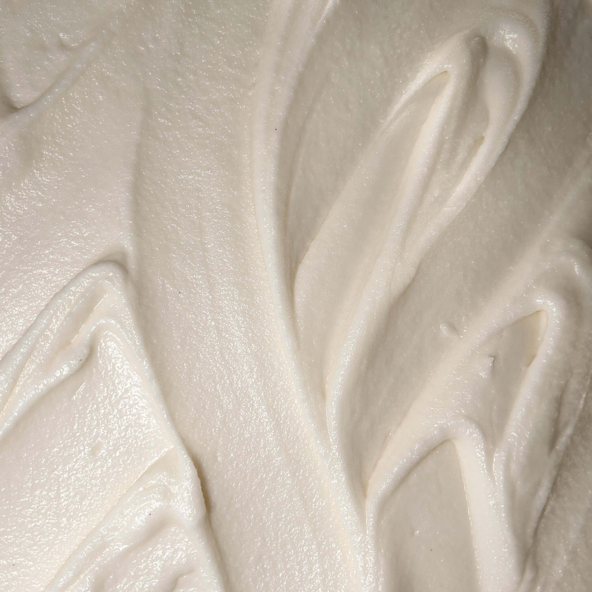 Creamy texture of Smoked Cedar Body Butter, a rich moisturizer for deeply nourishing and hydrating the skin.