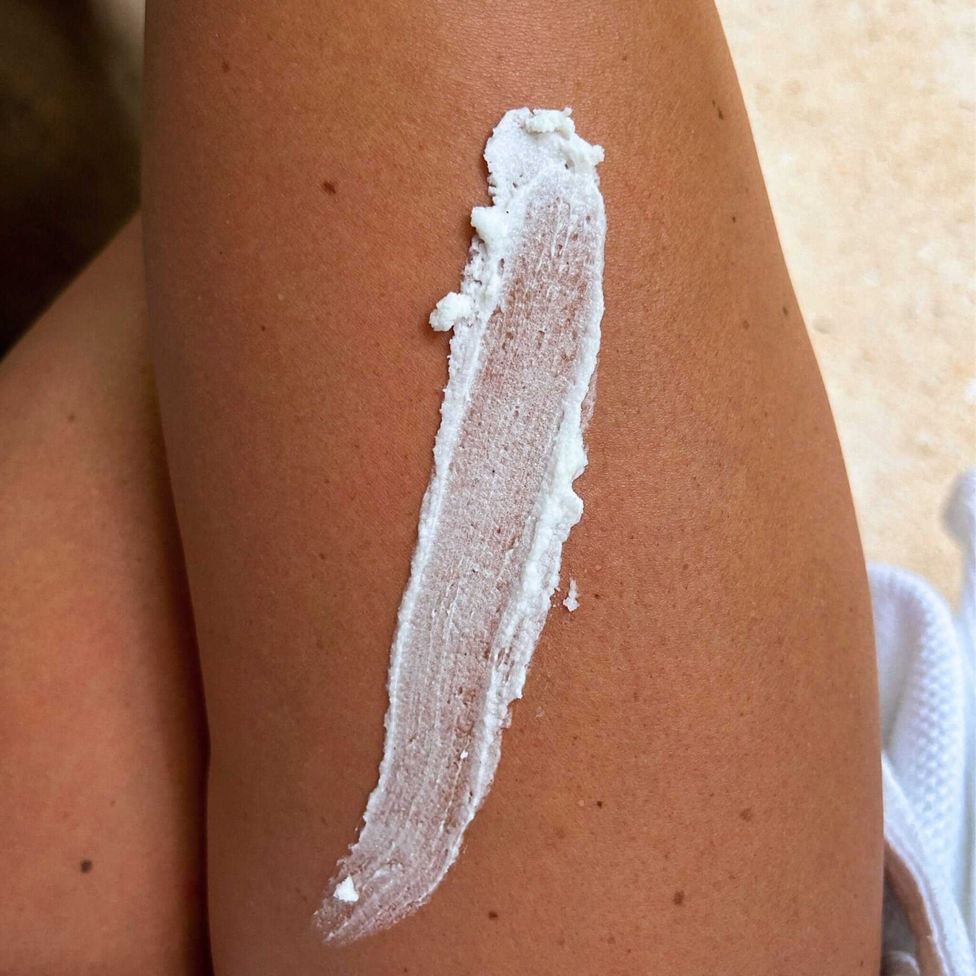 Vanilla Bean Body Butter spread on skin, showcasing its rich and creamy texture for deep moisturizing.