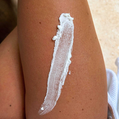 Vanilla Bean Body Butter spread on skin, showcasing its rich and creamy texture for deep moisturizing.