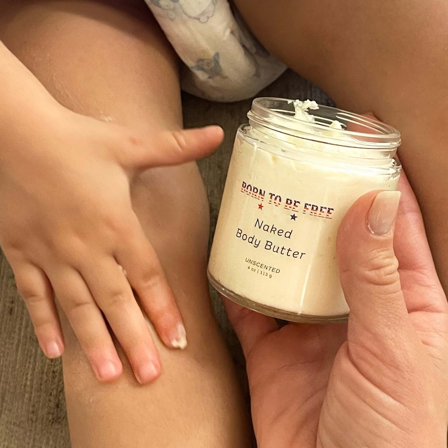 Baby Essentials Bundle- Non Toxic Baby Care with Naked Body Butter being applied on a child's skin.