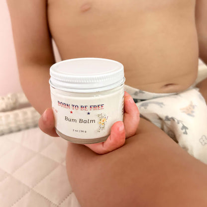 Baby Essentials Bundle- Non Toxic Baby Care Bum Balm in the hands of a child, promoting safe baby care.