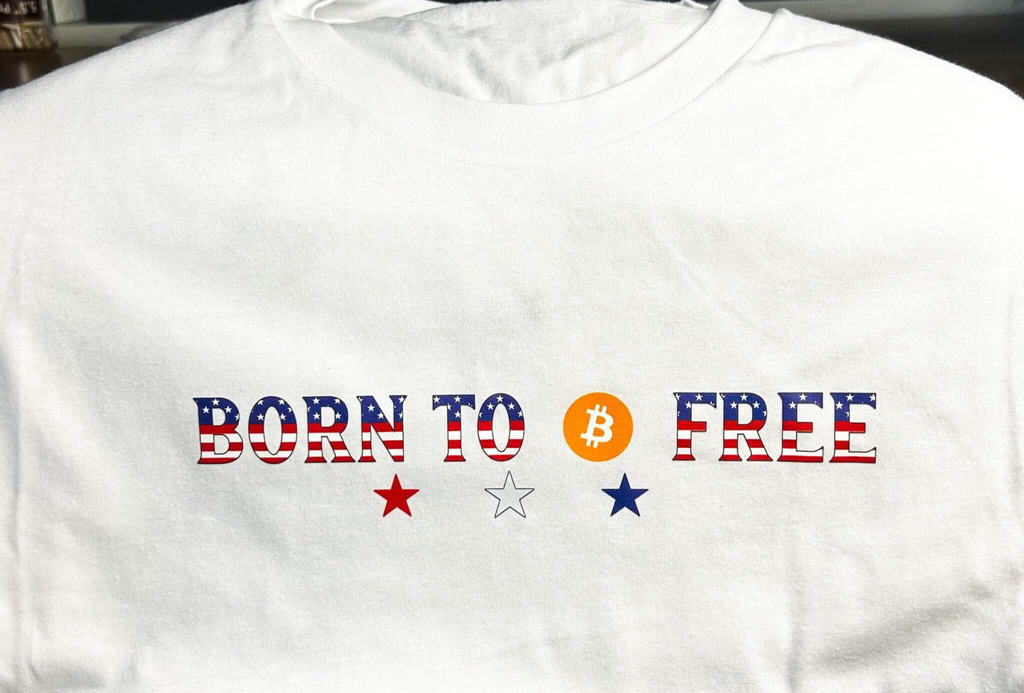 Feeding Forward T-shirts Born to Free T-shirt featuring patriotic colors and Bitcoin logo, perfect for freedom enthusiasts.