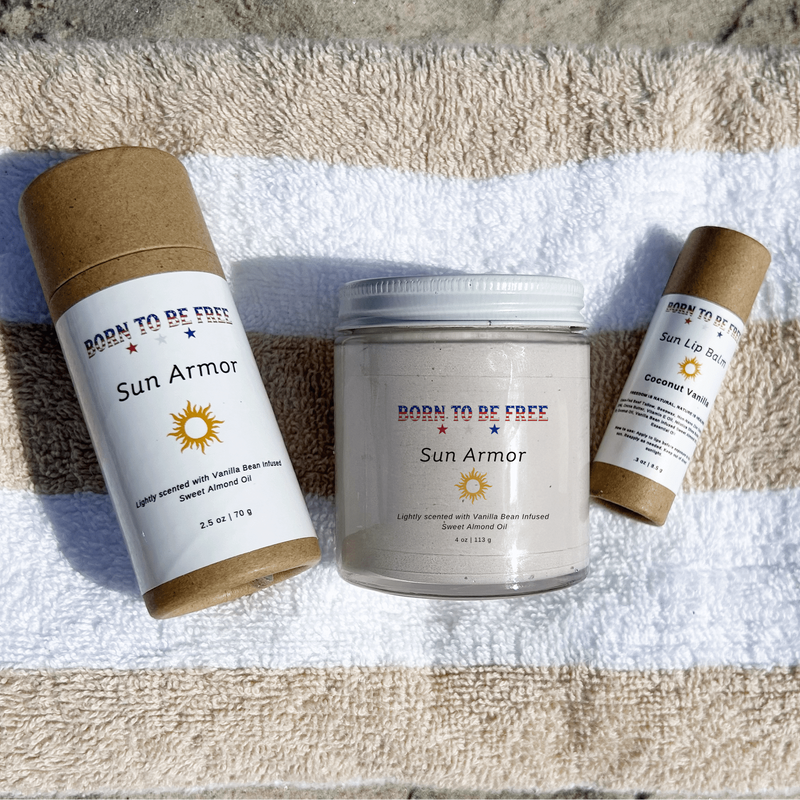 Summer Sun Essentials with Sun Armor products on a beach towel, featuring mineral-based sun care essentials.