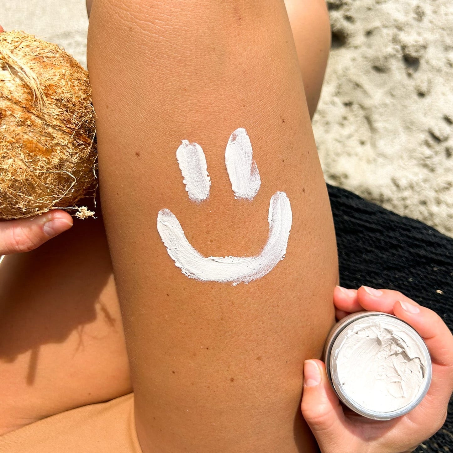 Mineral Based Sun Armor Bundle applied on skin with a smiley face design, showcasing all-natural UV protection.