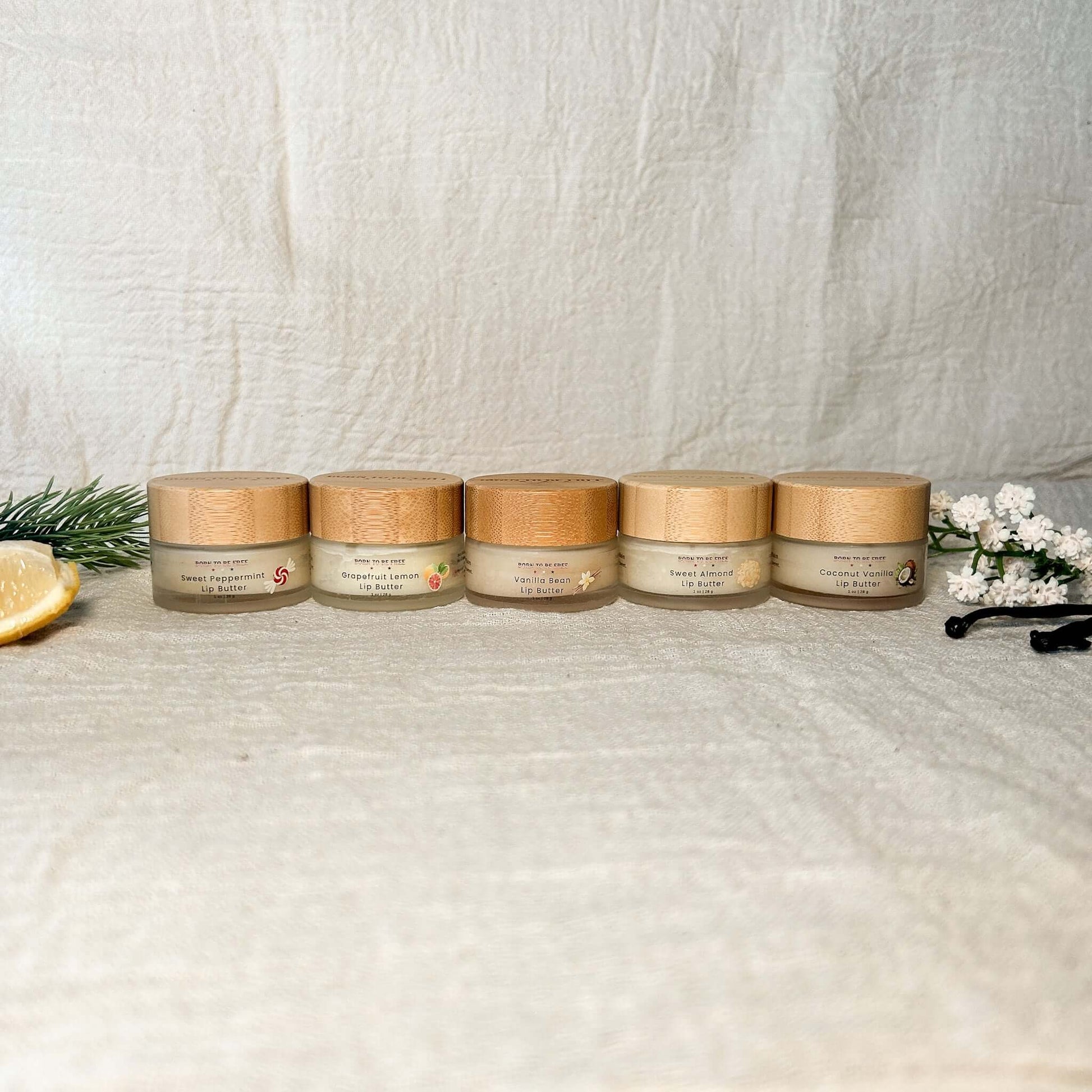 Tallow Lip Butter Set featuring five natural tallow based lip butters in compact jars on a textured background.
