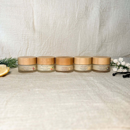 Tallow Lip Butter Set featuring five natural tallow based lip butters in compact jars on a textured background.