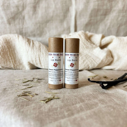 Sweet Peppermint Lip Balm in eco-friendly packaging displayed on a textured fabric background.