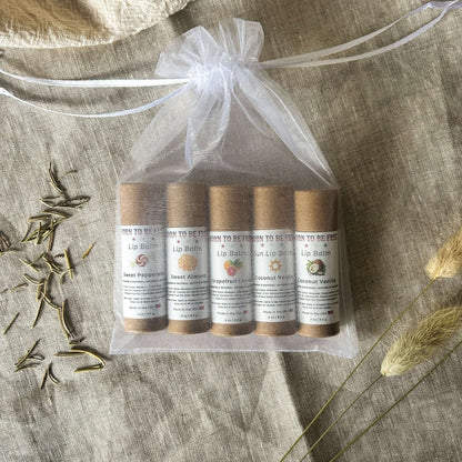 The Balm Bundle – Five all-natural lip balms in a drawstring bag with labels, including Sweet Peppermint and Coconut Vanilla.
