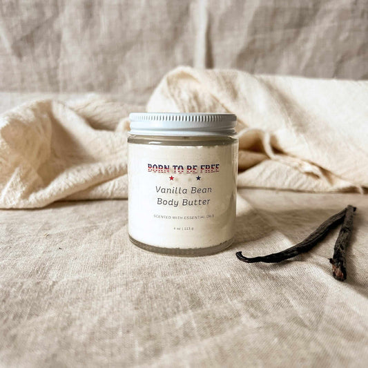 Vanilla Bean Body Butter in a jar on a neutral fabric background, showcasing its natural ingredients and soothing properties.