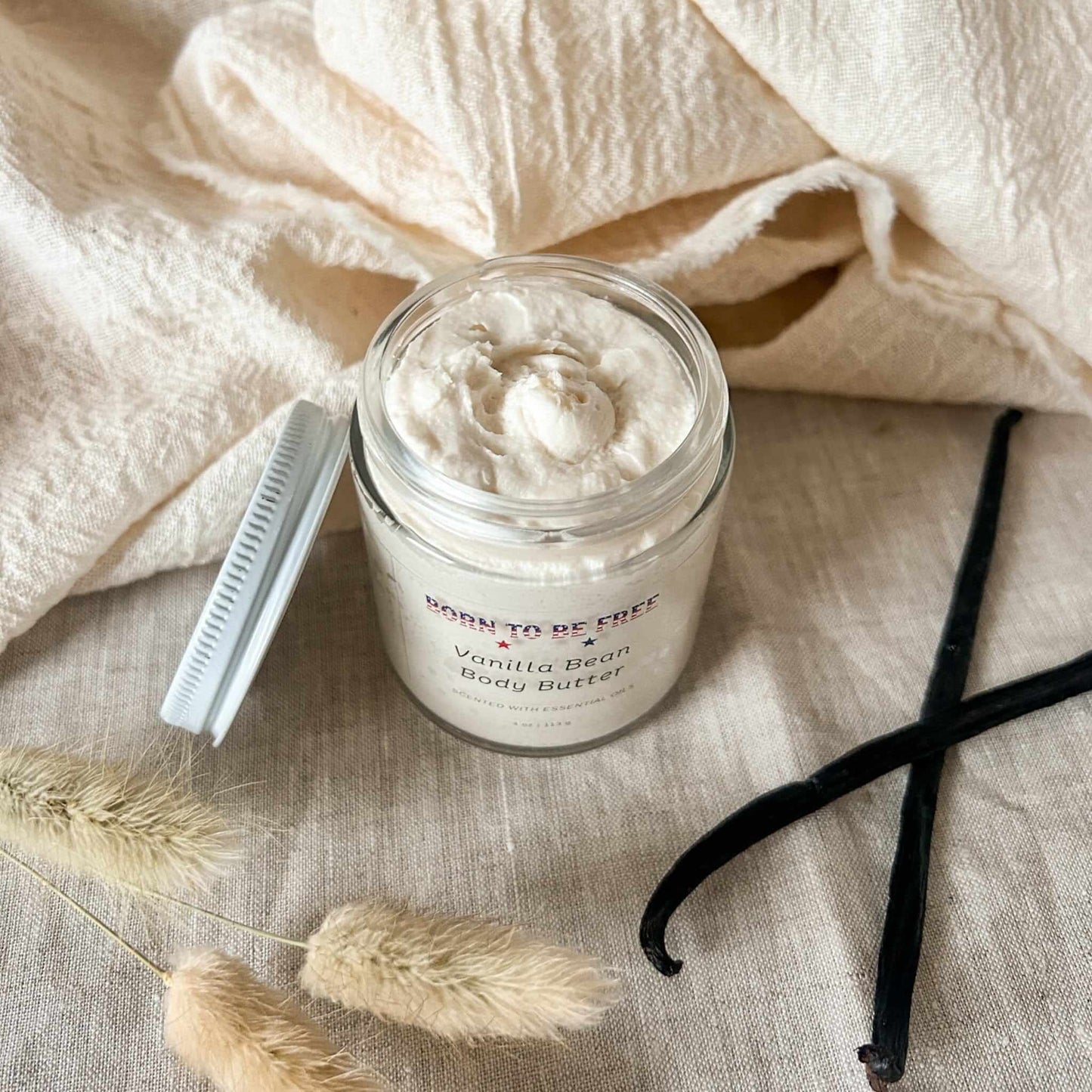 Vanilla Bean Body Butter in a glass jar on a soft background with natural decor.