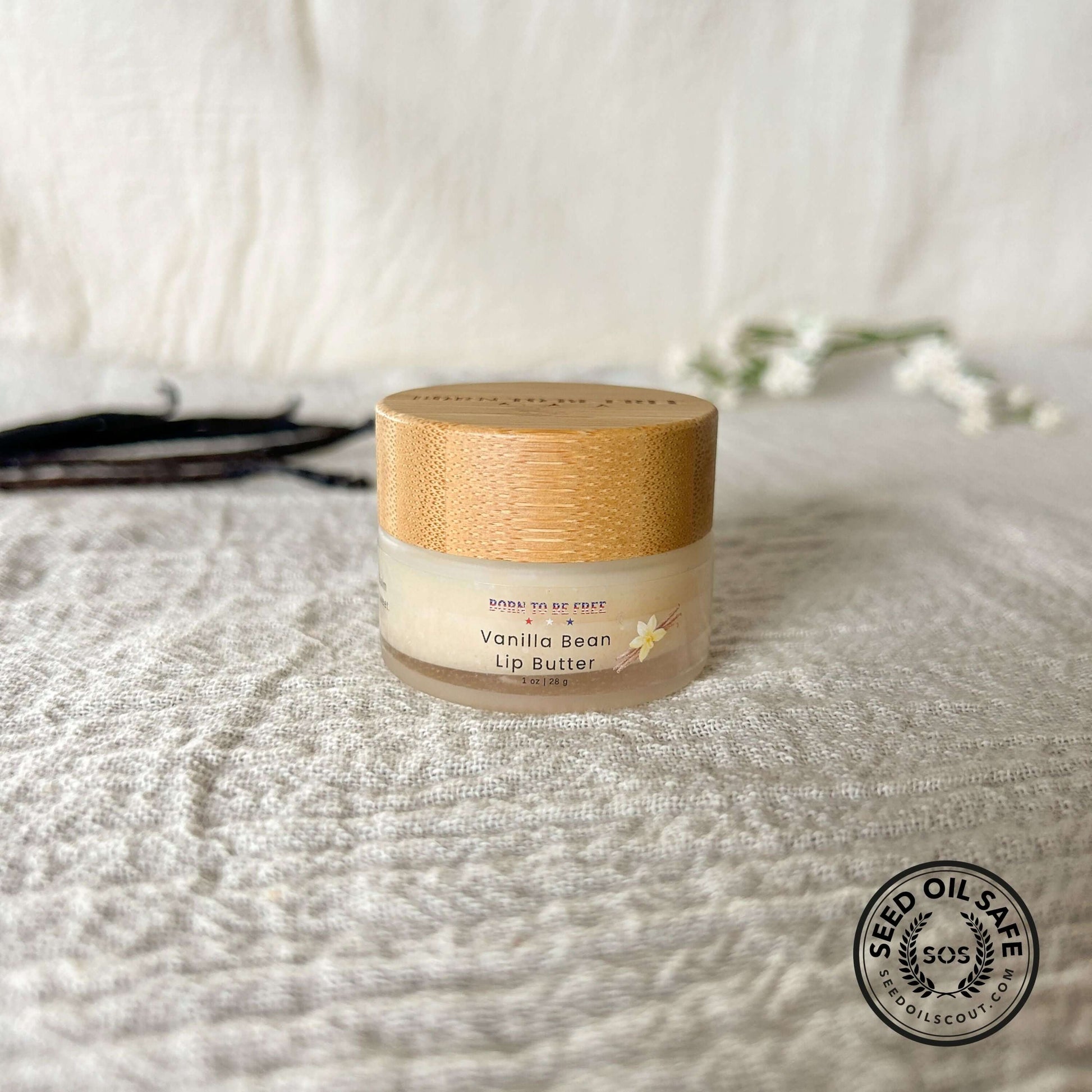 Vanilla Bean Lip Butter in a sleek container with a bamboo lid, perfect for nourishing and restoring dry lips.