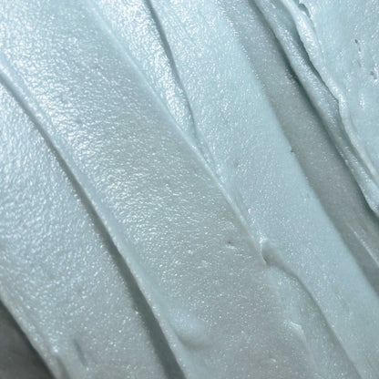 Hydrating Face Butter with Essential Oils showing a creamy, whipped texture in pale blue shade.